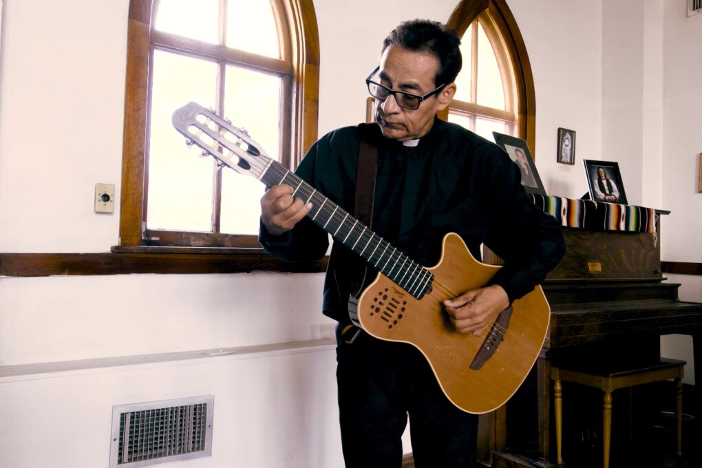Priest with a guitar