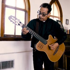 Priest with a guitar
