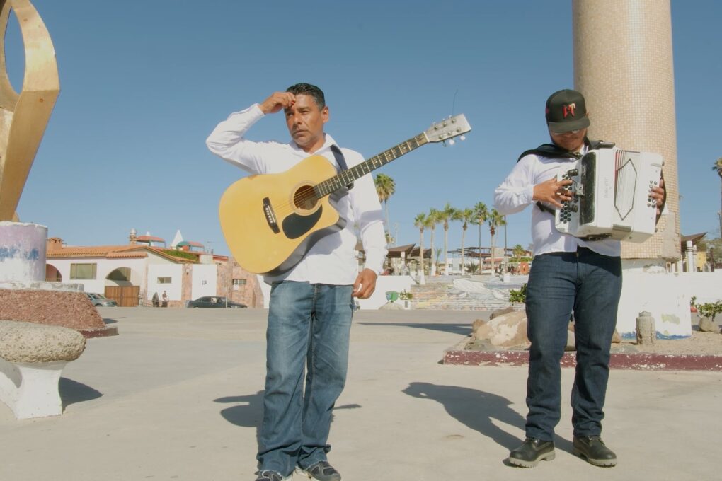 Man with a guitar and another with an accordion