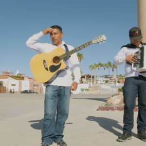 Man with a guitar and another with an accordion
