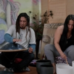 man and woman playing metal and singing bowls