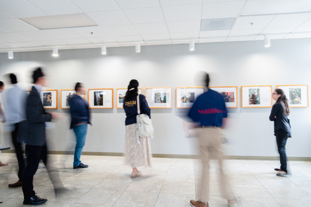 Gallery visitors viewing framed photographs